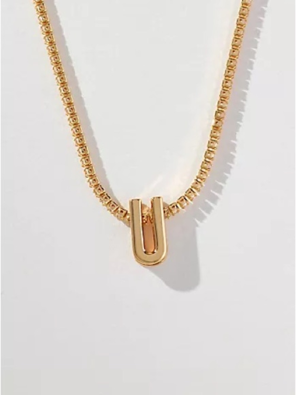 Anthropologie small shimmered “U” monogram necklace